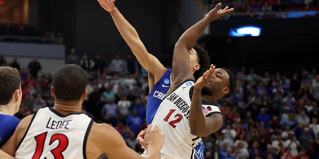 Ryan Nembhard #2 of the Creighton Bluejays fouls Darrion Trammell #12 of the San Diego State Aztecs during the second half of the Elite Eight round of the NCAA Men's Basketball Tournament at KFC YUM!  Center on March 26, 2023 in Louisville, Kentucky.