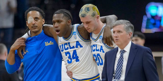 UCLA quarterback David Singleton, 34, is helped off the court during the second half of the second round of the college basketball game against the Northwestern at the NCAA Men's Tournament in Sacramento, California on Saturday, March 18, 2023.