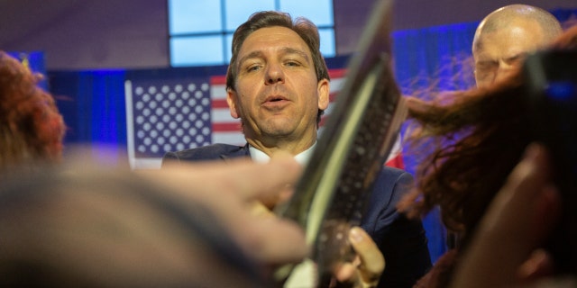 Florida Gov. Ron DeSantis signs books in Des Moines, Iowa, on March 10, 2023.