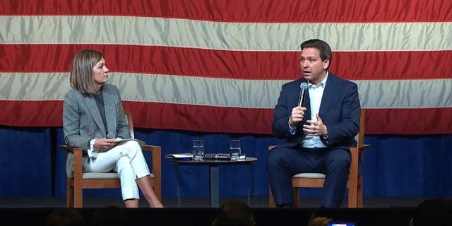 Republican Govs. Kim Reynolds of Iowa (left) and Ron DeSantis of Florida team up at an event in Davenport, Iowa, on March 10, 2023.