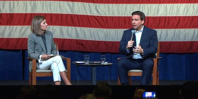 Republican Govs. Kim Reynolds of Iowa (left) and Ron DeSantis of Florida team up at an event in Davenport, Iowa, on March 10, 2023