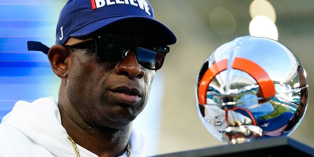 Sep 4, 2022; Miami, Florida, US; Jackson State Tigers head coach Deion Sanders receives the Orange Blossom Classic Trophy after beating Florida A&M Rattlers at Hard Rock Stadium.