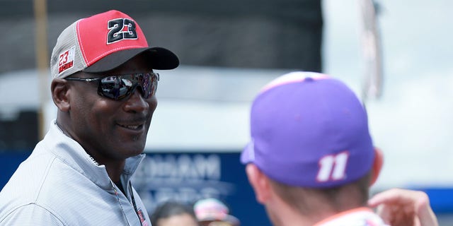 NBA Hall of Famer Michael Jordan meets with co-owner of 23XI Racing Denny Hamlin, driver of the #11 FedEx Ground Toyota, prior to the NASCAR Cup Series Pocono Organics CBD 325 at Pocono Raceway on June 26, 2021 in Long Pond, Pennsylvania. 