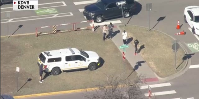 People waiting in front of East High school after a shooting took place in the building at Denver, Colorado.