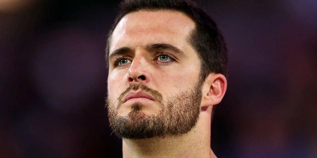 Derek Carr, #4 of the Las Vegas Raiders, stands on the sidelines during the national anthem prior to an NFL football game against the Los Angeles Rams at SoFi Stadium on Dec. 8, 2022 in Inglewood, California.