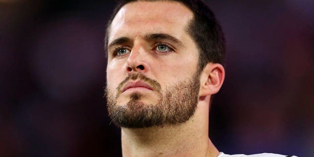 Derek Carr listens to the national anthem