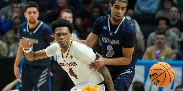 Arizona State's Desmond Cambridge Jr. (4) and Nevada's Trey Pettigrew (3) go for a loose ball during the first half of a First Four college basketball game in the NCAA men's basketball tournament, Wednesday, March 15, 2023, in Dayton, Ohio. 