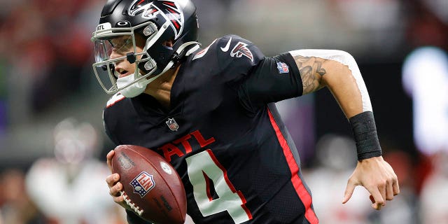 Desmond Ridder, #4 of the Atlanta Falcons, fights with the ball against the Tampa Bay Buccaneers during the second quarter at Mercedes-Benz Stadium on January 8, 2023 in Atlanta.