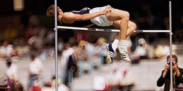 FILE - Dick Fosbury, of the United States, clears the bar in the high jump competition at the 1968 Mexico City Olympics.