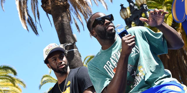 Andrew Wiggins, left, and Draymond Green of the Golden State Warriors during their 2022 Victory Parade and Rally June 20, 2022, at Chase Center in San Francisco.