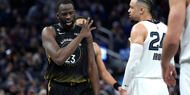 Draymond Green (23) of the Golden State Warriors and Dillon Brooks (24) of the Memphis Grizzlies exchange words during the second quarter at the Chase Center on December 25, 2022 in San Francisco.