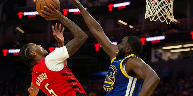 Portland Trail Blazers forward Cam Reddish (5) shoots over Golden State Warriors forward Draymond Green (23) during the second quarter at Chase Center in San Francisco Feb. 28, 2023.
