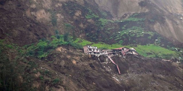 Homes are destroyed after a deadly landslide caused by heavy rains that buried dozens of homes in Alausi, Ecuador, on March 27, 2023.