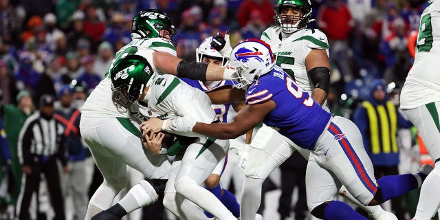 Ed Oliver #91 of the Buffalo Bills fires Zach Wilson #2 of the New York Jets during the third quarter at Highmark Stadium on January 9, 2022 in Orchard Park, New York.