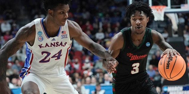Howard's Elijah Hawkins, #3, attempts to pass KJ Adams Jr. of Kansas during the second half of a first-round college basketball game in the NCAA Tournament on Thursday, March 16, 2023, in Des Moines, Iowa.