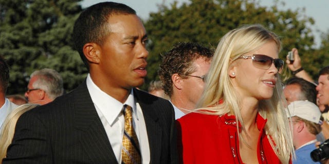 Tiger Woods and Elin Nordegren leave the stage after opening ceremonies at the Ryder Cup in Detroit, Michigan, Sept. 16, 2004.