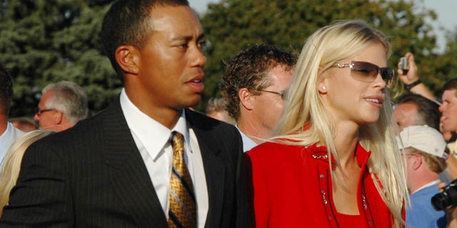 Tiger Woods and Elin Nordegren leave the stage after opening ceremonies at the Ryder Cup in Detroit, Michigan, Sept. 16, 2004.