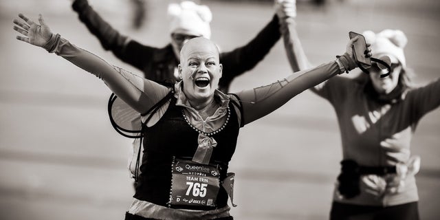 Erin Gratsch, who has been battling breast cancer, triumphantly finished the Queen Bee Half Marathon in October 2022.