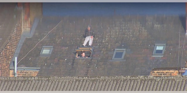 Merseyside Police failed to notice suspect Etmond Lika, 32, a meter away on the rooftops during a strip search.