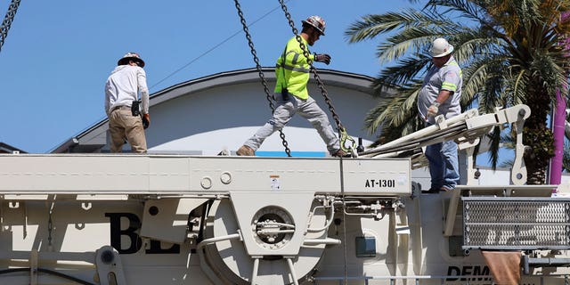 Work crews assemble the cranes that will be used to dismantle the Orlando FreeFall at ICON Park, on March 14, 2023 in Orlando, Florida.