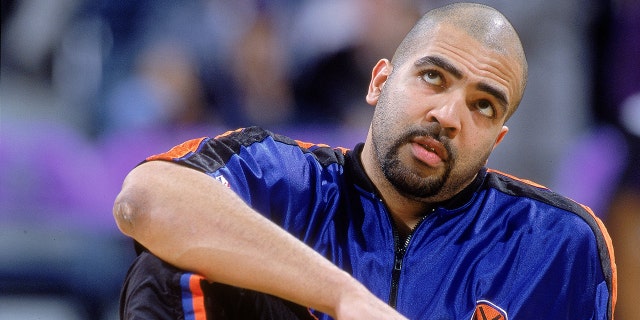 Felton Spencer, #50 of the New York Knicks, stretches out on the court before the game against the Milwaukee Bucks at the Bradley Center in Milwaukee. The Bucks won 105-91.