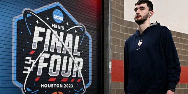 Alex Karaban of the Connecticut Huskies walks during media availability for the Final Four as part of the NCAA Tournament at NRG Stadium March 30, 2023, in Houston.