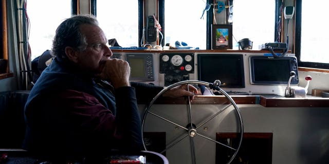 Bob Maharry sits inside his fishing boat docked at Pier 45 in San Francisco, on March 20, 2023.