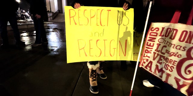 Protest sign outside Framingham city hall calling for Michael Hugo to resign following his controversial comments on abortion.