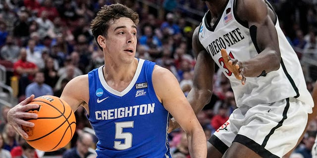 Creighton guard Francisco Farabello (5) pushes against San Diego State forward Nathan Mensah (31) in the first half of an Elite 8 college basketball game in the NCAA South Regional Tournament, Sunday, May 26. March 2023, in Louisville, Ky.