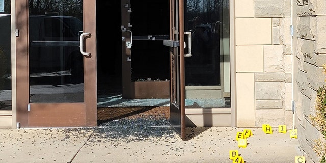 Bullet holes can be seen in the side entrance where the 28-year-old suspected shooter gained entry.