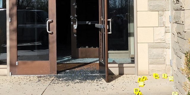 Bullet holes can be seen in the side entrance where the 28-year-old suspected shooter gained entry.