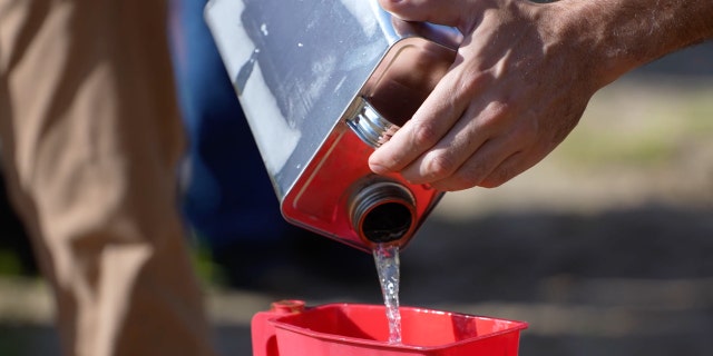 Synthetic jet fuel made from captured carbon dioxide is poured into a small, unmanned jet at Hsu STEM Range in Laurel Hill, Florida, July 27, 2022.