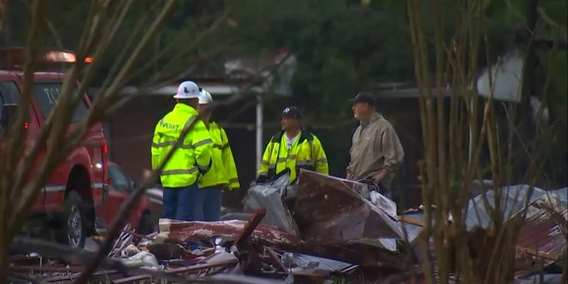 Crews assess the damage in Troup County, Georgia, after a tornado barreled through early Sunday.