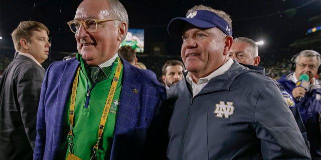 Athletic Director Jack Swarbrick and Head coach Brian Kelly of the Notre Dame Fighting Irish speak following the game against the Stanford Cardinal at Notre Dame Stadium on September 29, 2018 in South Bend, Indiana.