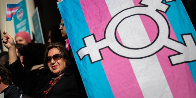Des militants LGBT et leurs partisans se rassemblent pour soutenir les personnes transgenres sur les marches de l'hôtel de ville de New York, le 24 octobre 2018 à New York. 