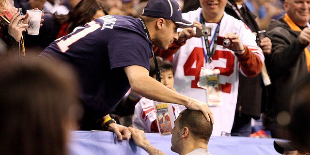 Patriots player Aaron Hernandez greets his brother Jonathan during the pre-game warm-up before the Super Bowl in Lucas Oil Stadium. New England Patriots against New York Giants Super Bowl XLVI at Lucas Oil Stadium in Indianapolis, IN on Sunday, February 5, 2012. 