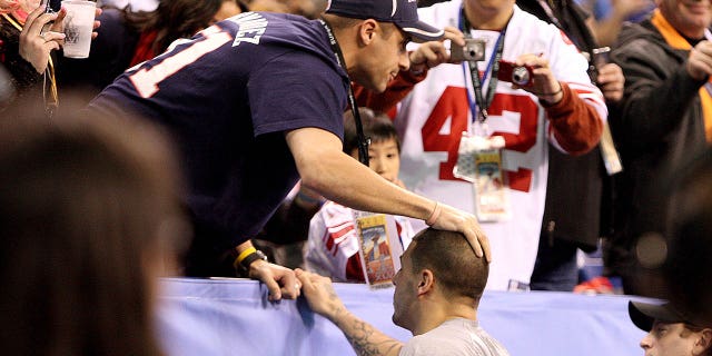 Patriots player Aaron Hernandez greets his brother Jonathan during the pre-game warm-up before the Super Bowl in Lucas Oil Stadium. New England Patriots against New York Giants Super Bowl XLVI at Lucas Oil Stadium in Indianapolis, IN on Sunday, February 5, 2012.