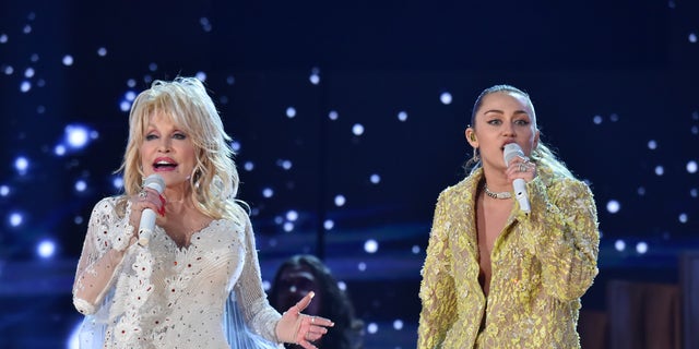 Dolly Parton (L) and Miley Cyrus perform on stage during the 61st Annual GRAMMY Awards at Staples Center on February 10, 2019 in Los Angeles, California.