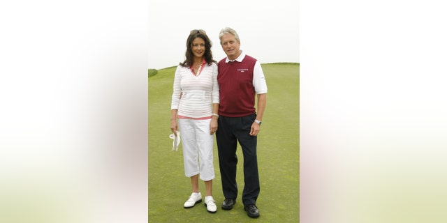 Michael Douglas admitted his wife Catherine Zeta-Jones makes him "whip it out" if he loses on the golf course.