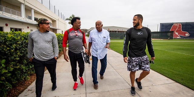 Juan Centeno, #68, former pitcher Pedro Martinez, former director of the Boston Red Sox Dominican Academy Jesús Alou, and Eduardo Rodriguez, #57 of the Boston Red Sox, exit JetBlue Park at Fenway South before going fishing after a team workout on March 5, 2019, in Sanibel, Florida. 