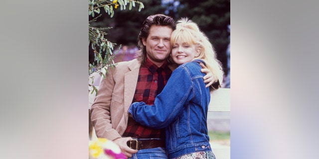 Goldie Hawn and Kurt Russell pose for a portrait while filming "Overboard" in October 1987 in Fort Bragg, California.