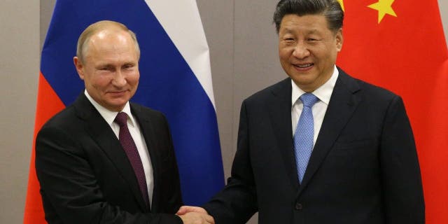 Russian President Vladimir Putin shakes hands with Chinese President Xi Jinping during a bilateral meeting on Nov. 13, 2019, in Brasilia, Brazil.