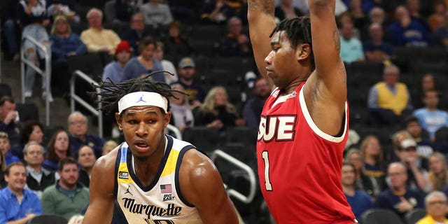 Marquette Golden Eagles forward Justin Lewis, #10, goes around SIU Edwardsville Cougars forward DeeJuan Pruitt, #1, during a game between the Marquette Golden Eagles and the Southern Illinois University Edwardsville Cougars at the Fiserv Forum on Nov. 9, 2021 in Milwaukee.