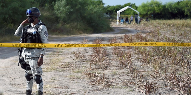 A member of the National Guard guards the entrance to a property called "La Bartolina" in the border city of Matamoros, Tamaulipas state, Mexico on August 23, 2021.