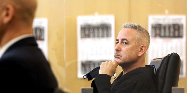 Judge Daniel Lowenthal, right, listens during a hearing at Governor George Deukmejian Courthouse in Long Beach, California, on Jan. 19, 2022.