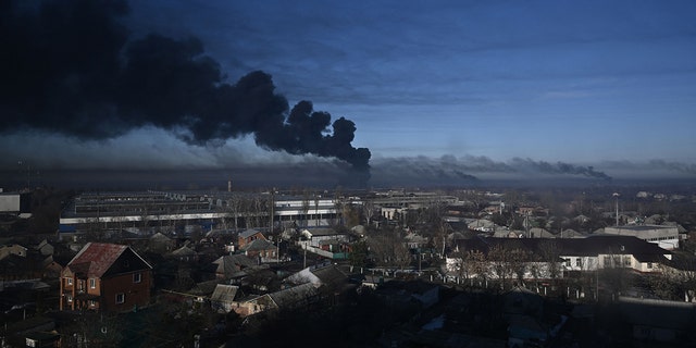 Black smoke billows from a military airfield in Chuguyev near Kharkiv on February 24, 2022. 