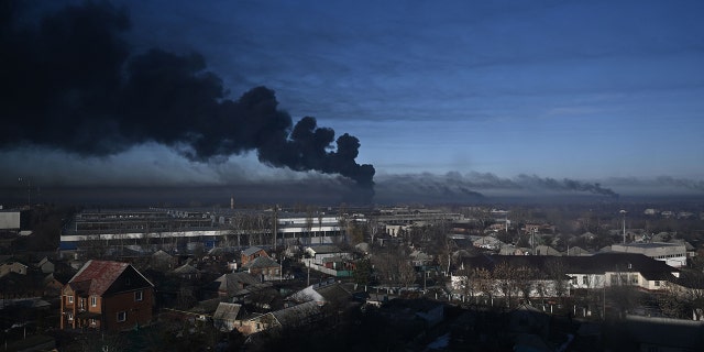 Black smoke rises from a military airport in Chuguyev near Kharkiv on February 24, 2022.