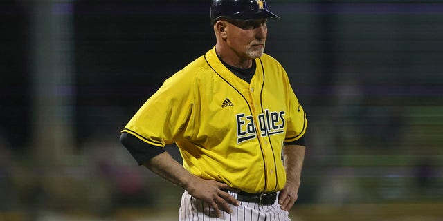 Southern Miss head coach Scott Berry coaches at third base during a college baseball game between the Southern Miss Golden Eagles and the Mississippi State Bulldogs on March 2, 2022, at Trustmark Park, Pearl, Mississippi.