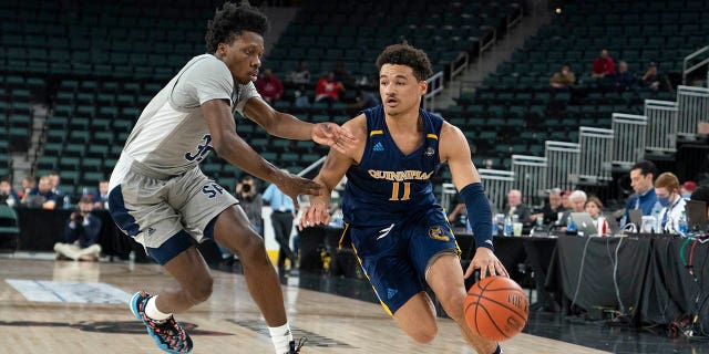 Quinnipiac Bobcats Guard Dezi Jones (11) dribbles the ball against St. Peter's Peacocks Guard Jaylen Murray (32) during the first half of a MAAC Conference basketball tournament quarterfinal game March 11, 2022, at Boardwalk Hall in Atlantic City, N.J.
