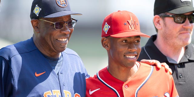 Houston Astros manager Dusty Baker poses with his son, Washington Nationals minor leaguer Darren Baker, after exchanging lineups before a spring training game at The Ballpark of The Palm Beaches on March 19, 2022, in West Palm Beach, Florida. 